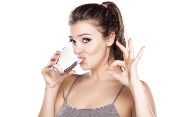 Девушка пьет минеральную воду